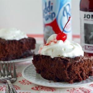 Diet Cherry Soda Brownies with whipped cream on plates