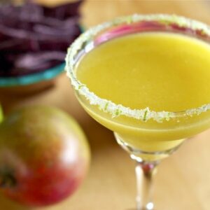 Overhead view of a mango margarita in a glass with a sugared rim