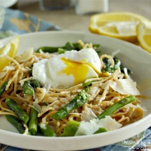 Pasta with asparagus and poached egg in a bowl