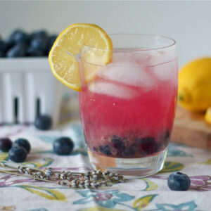 Side view of a glass of lavender blueberry lemonade