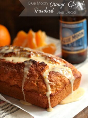 A loaf of Blue Moon Orange-Glazed Beer Bread on parchment paper