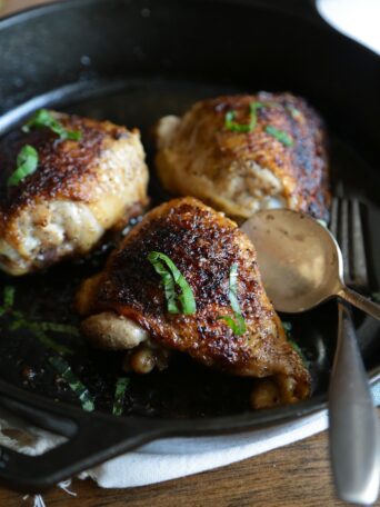 Overhead view of Crispy Chicken Thighs in a skillet