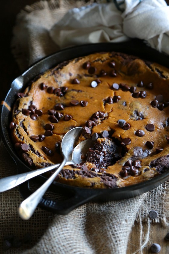 Brownie in a cast iron skillet with two antique forks