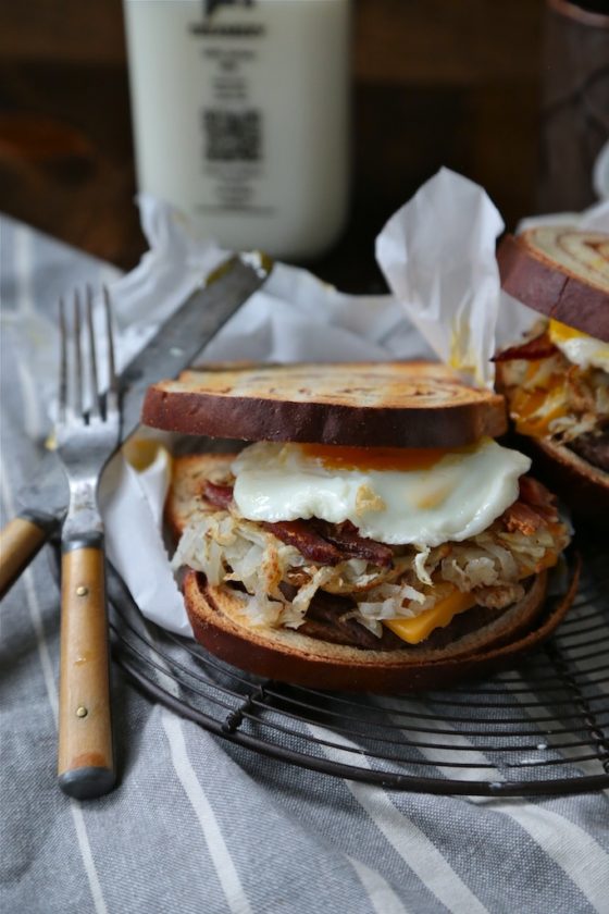 Cinnamon Swirl Loaded Breakfast Sandwich - homemadehome.com Filled with bacon, sausage, hashbrowns and topped with a soft egg! You can't turn down this beast!