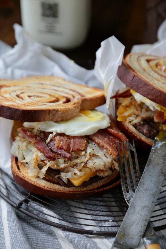 Cinnamon Swirl Loaded Breakfast Sandwich - homemadehome.com Filled with bacon, sausage, hashbrowns and topped with a soft egg! You can't turn down this beast!