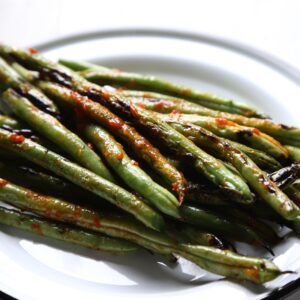 Grilled Green Beans with Harissa - a super healthy, paleo, and Whole30 friendly way to enjoy the best that summer has to offer!