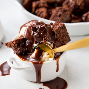 Nutella Hot Fudge with chocolate brownies and golden spoon in white dish