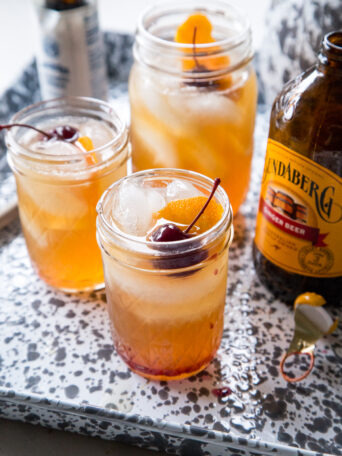 Bourbon Amaretto Coolers in glasses on a gray and white sheet pan
