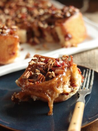 Bourbon Bacon Pecan Sticky Bun on plate with fork