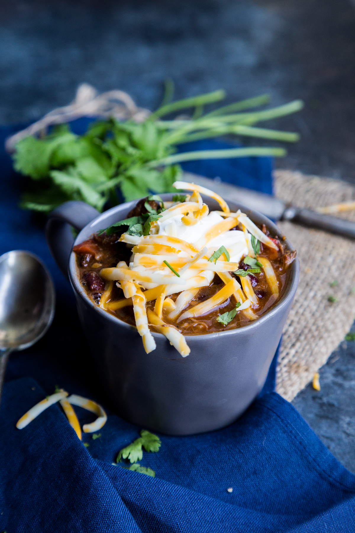 This low and slow cooked chili is packed with shredded beef and beans, and then topped with cheese for the most excellent chili con carne you have ever had! 