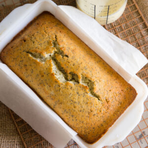Almond Orange Poppyseed Pound Cake unfrosted in white ceramic loaf pan