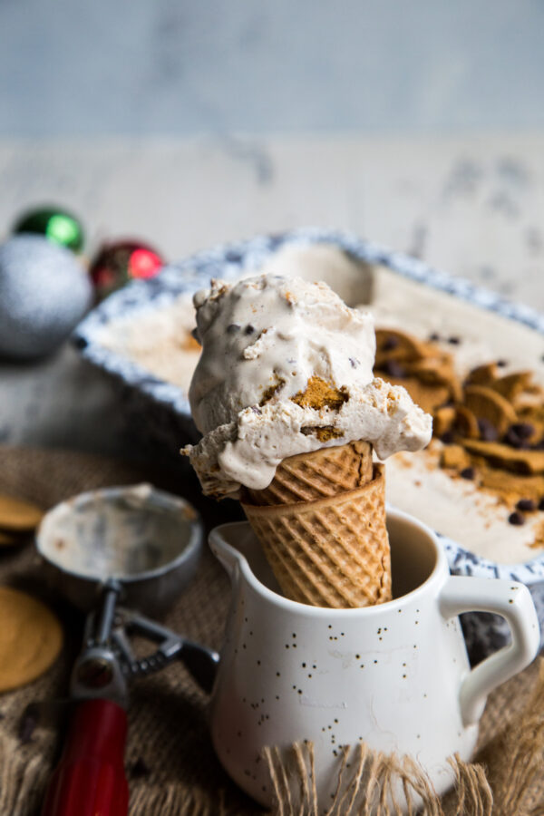 Gingerbread Chocolate Chip No Churn Ice Cream in a cone with an ice cream scoop