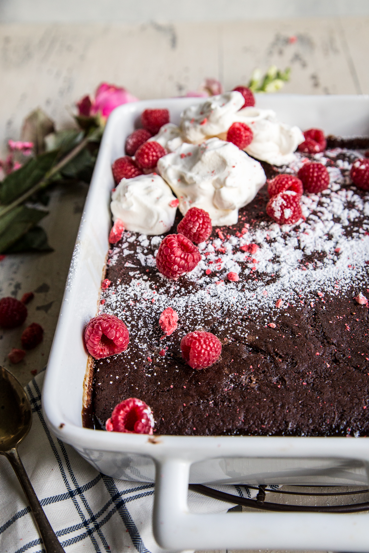 Chocolate Raspberry Espresso Pudding Cake with whipped cream and raspberries