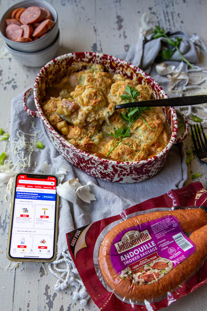 Full on comfort food with andouille sausage and chicken pot pie, topped with cheesy herbed biscuits with sausage and mobile app on phone displayed