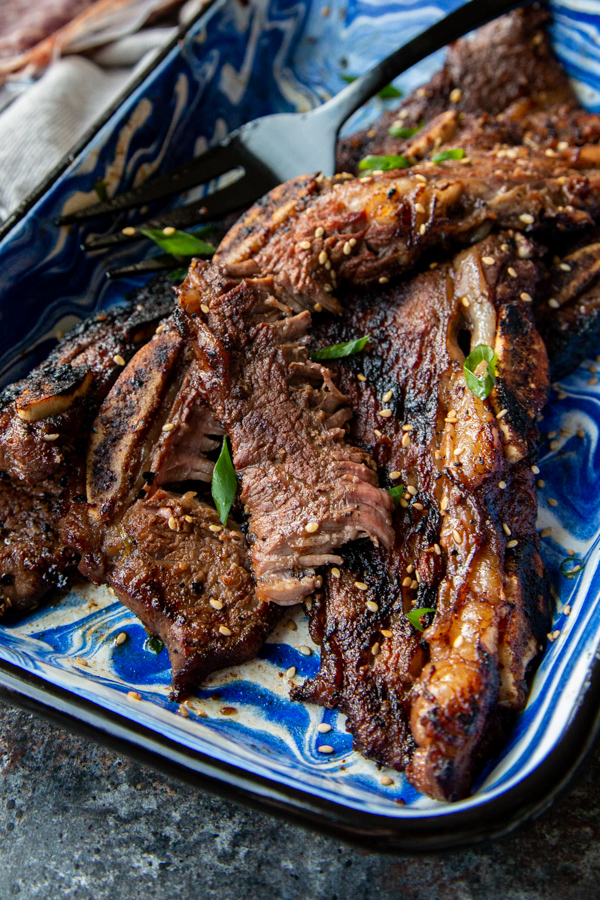 Asian Grilled Flanken Short Ribs shot overheat in blue and white dish and shredded