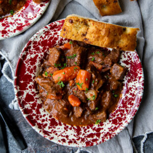Instant Pot Beef Bourguignon overhead on a dark surface and napkin