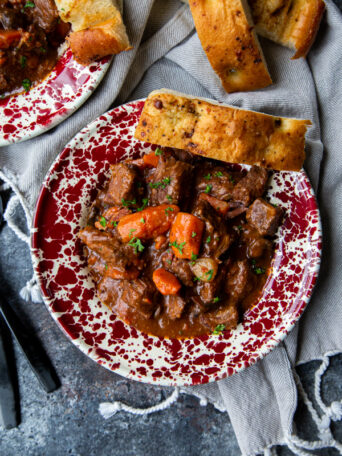 Instant Pot Beef Bourguignon overhead on a dark surface and napkin