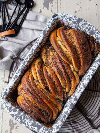 Overhead view of a loaf of Lemon Almond Poppyseed Babka in a loaf pan