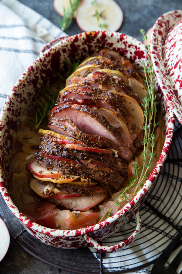 Whole Roasted Ham With Honey Mustard Glaze and Apples with sprigs of fresh thyme