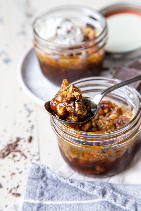 A spoonful of pecan pie resting on a mason jar