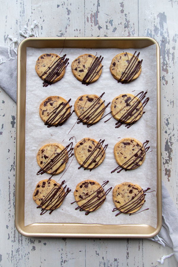 Chocolate orange shortbread cookies on a gold baking sheet
