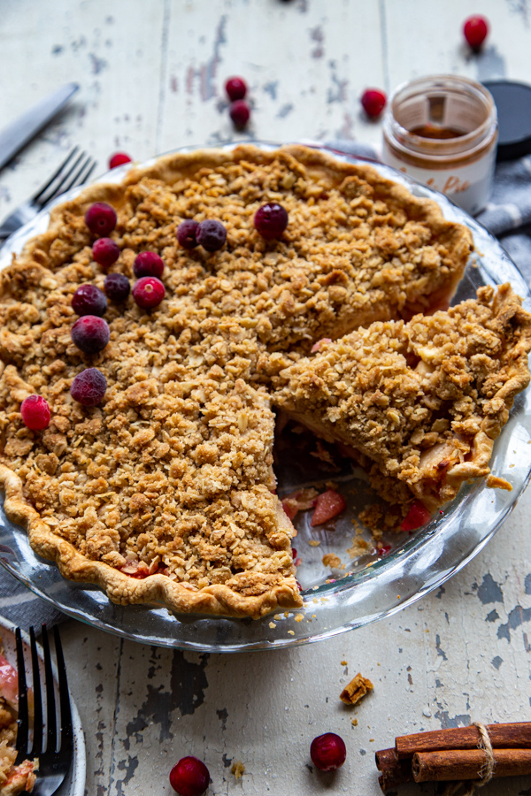 Whole Cranberry Dutch Apple Pie with one large cut slice