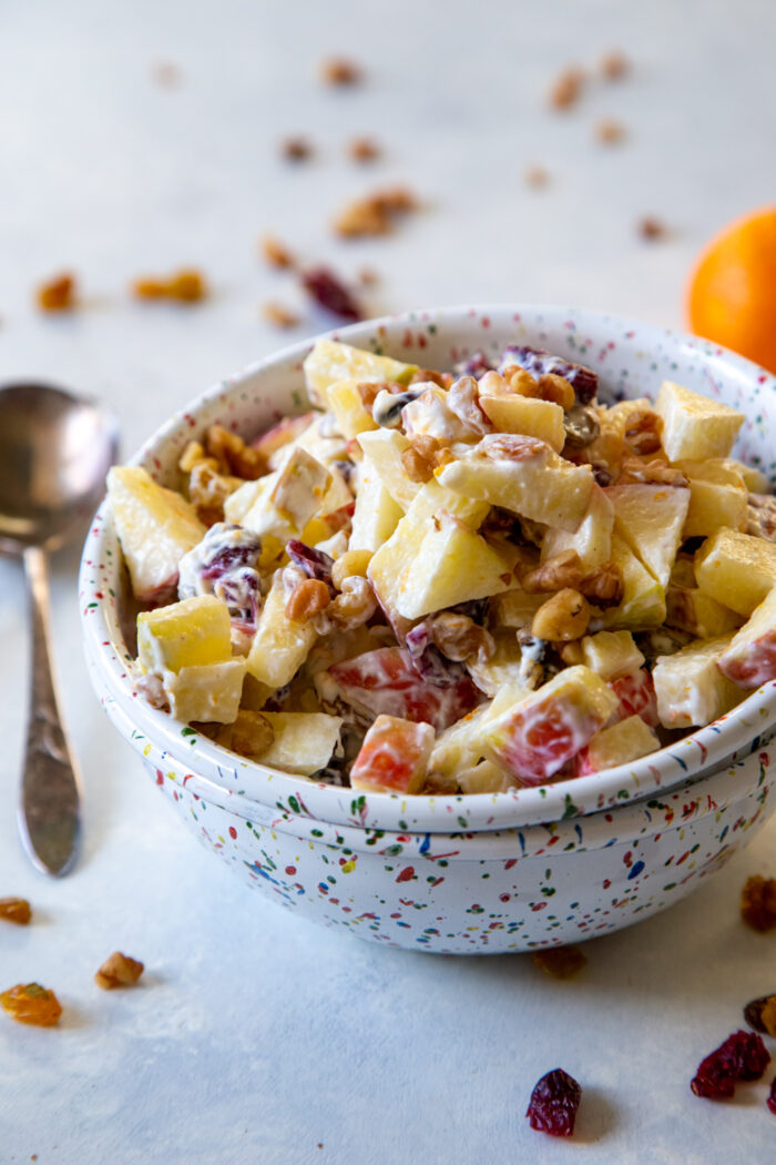 Cranberry Orange Apple Salad in a confetti sprinkled white bowl
