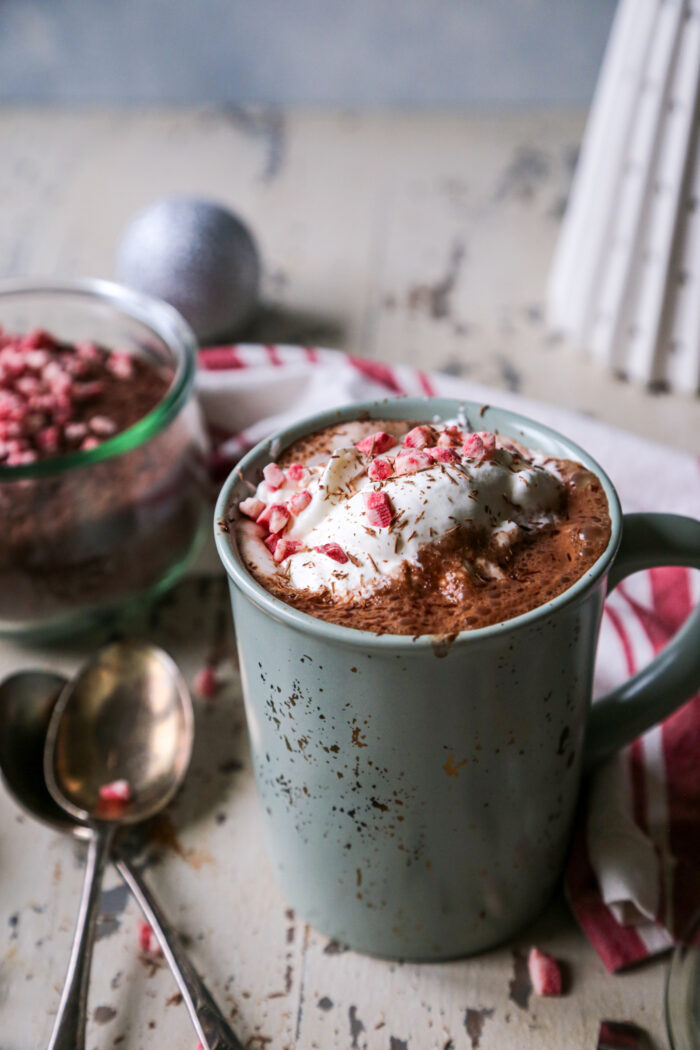 Peppermint Hot Cocoa Mix on a distressed background in a green and gold flecked mug